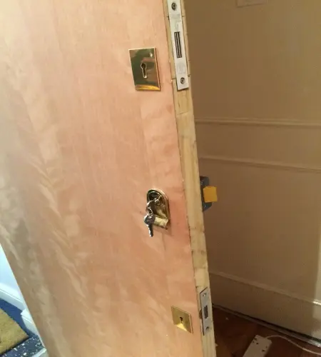emergency locksmith newly installed door with 3 shiny locks 