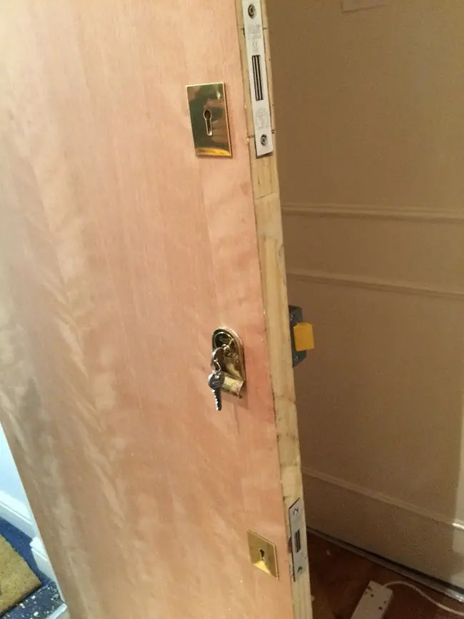 emergency locksmith newly installed door with 3 shiny locks 